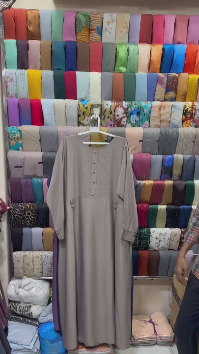 Product video showcasing the Bareqa Belt Abaya in premium Zoom Nida fabric with an adjustable waist belt, elegant cuff sleeves, and a modest flowing fit.