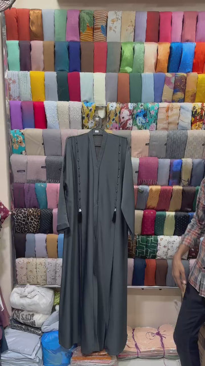 Noor Charcoal Pearl Tassel Abaya made from premium Imported Nida fabric featuring elegant front pearl tassels and a stylish front open design for modest Islamic fashion.